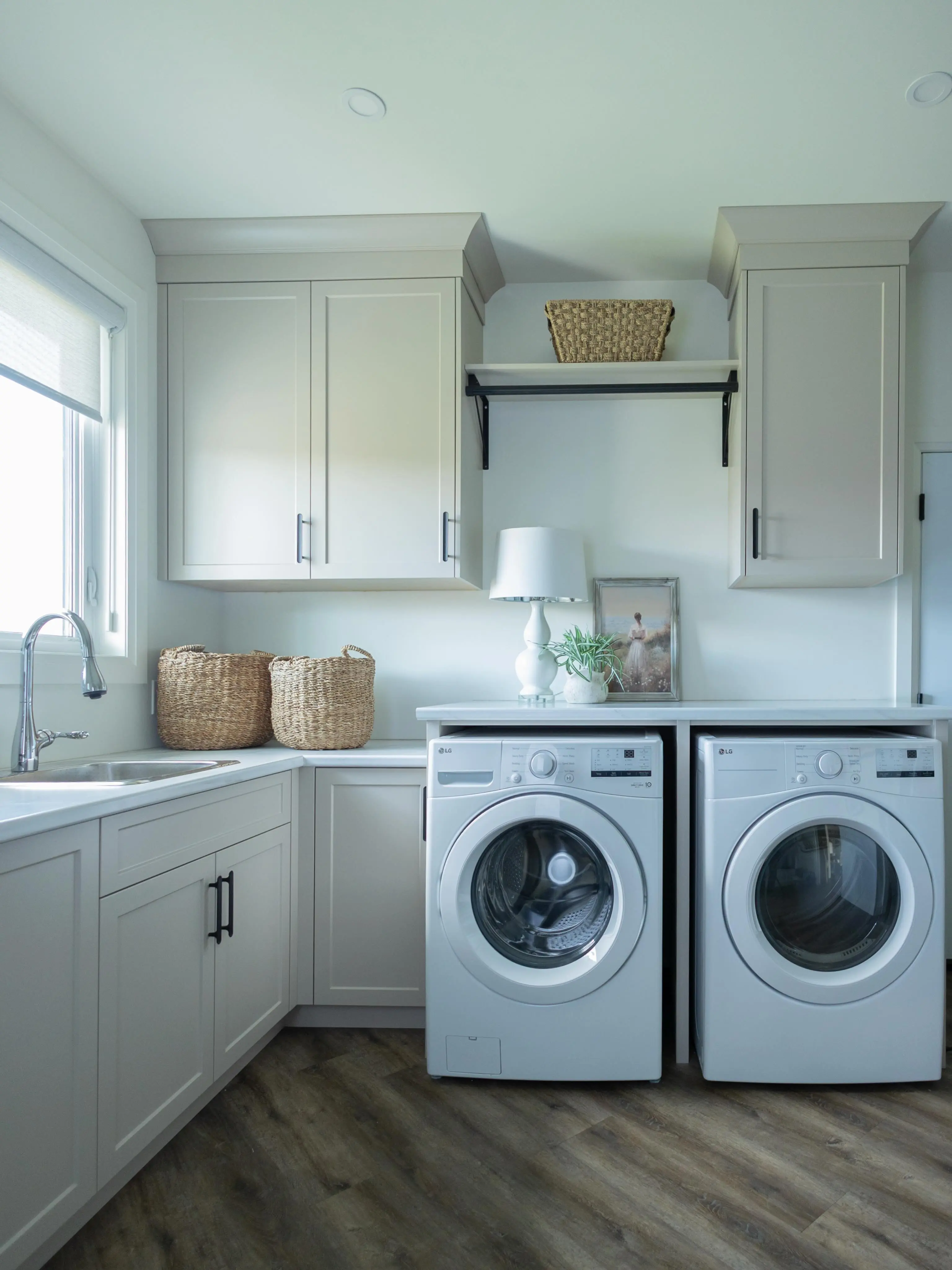 Painted stone laundry with shelf cabinetry by Heirlooms Custom Cabinetry