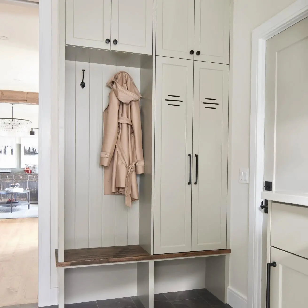 Mudroom with storage and vented cabinetry by Heirlooms Custom Cabinetry