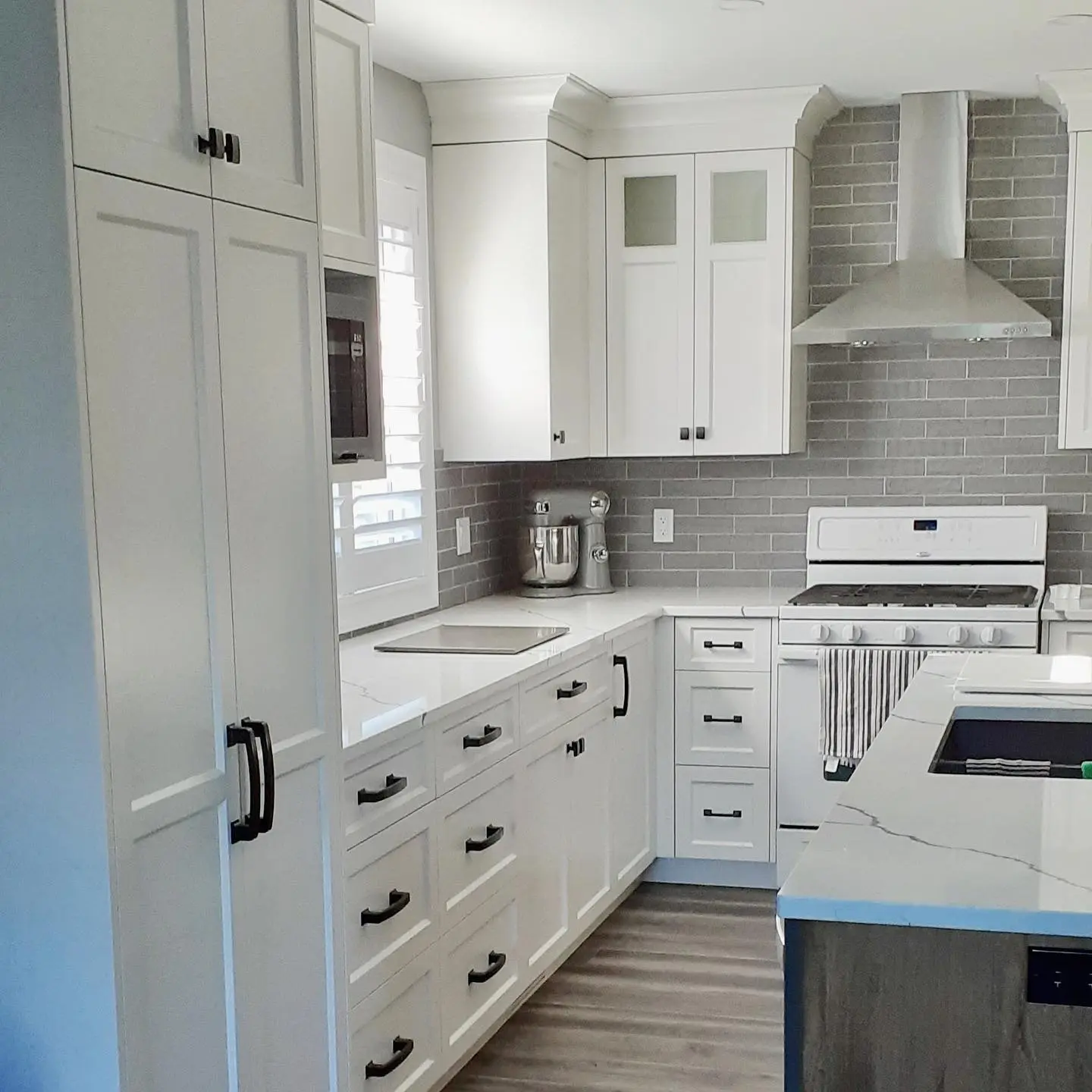 Stained maple kitchen with island and perimeter cabinetry by Heirlooms Custom Cabinetry