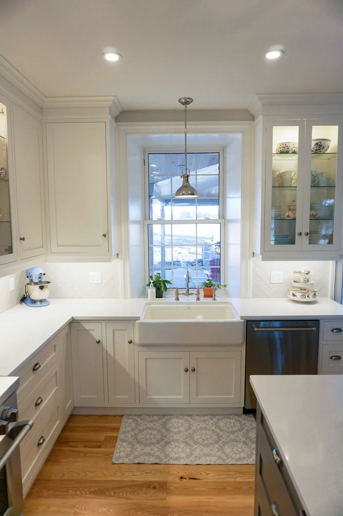 Painted kitchen with island cabinetry by Heirlooms Custom Cabinetry