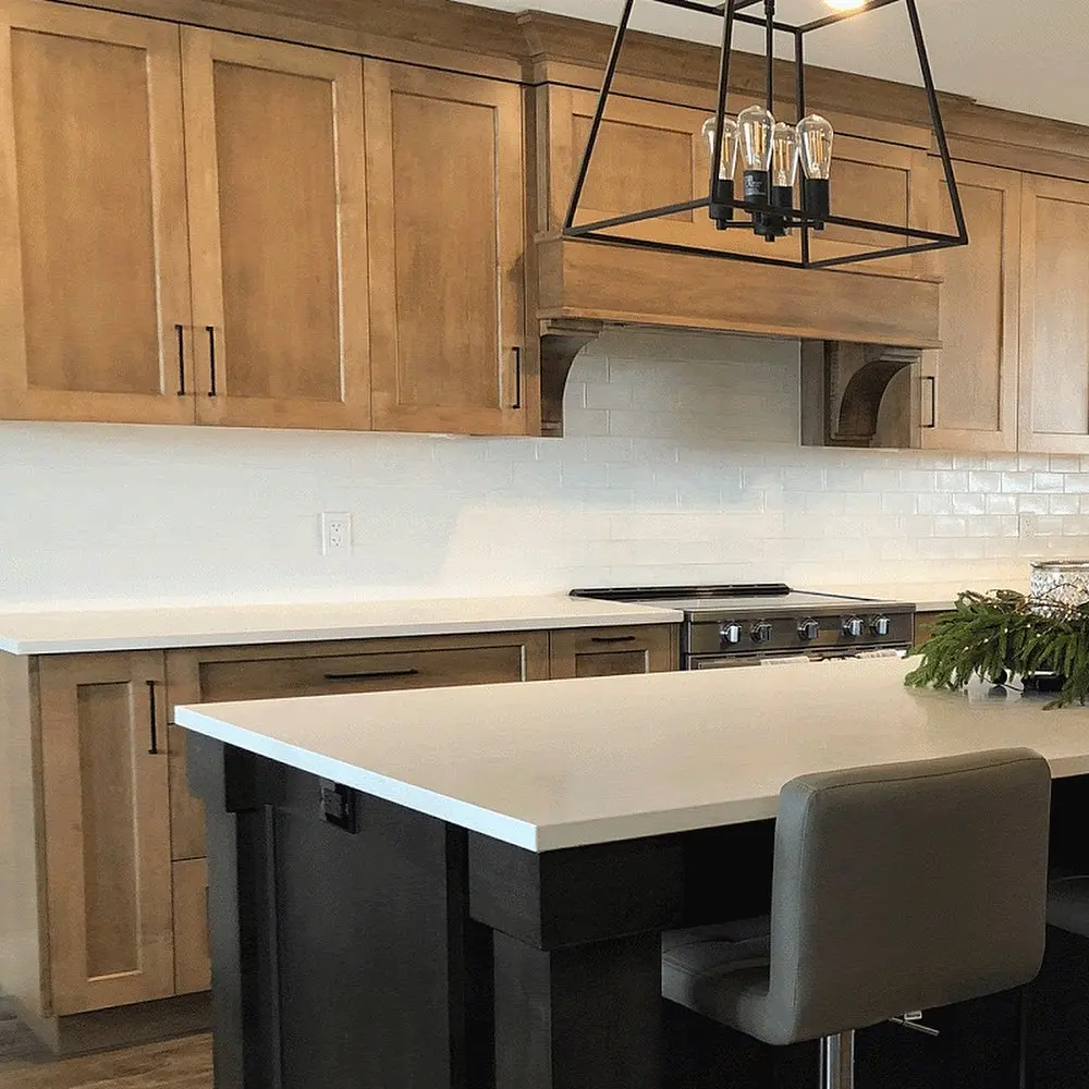 Stained oak kitchen with island and perimeter cabinetry by Heirlooms Custom Cabinetry