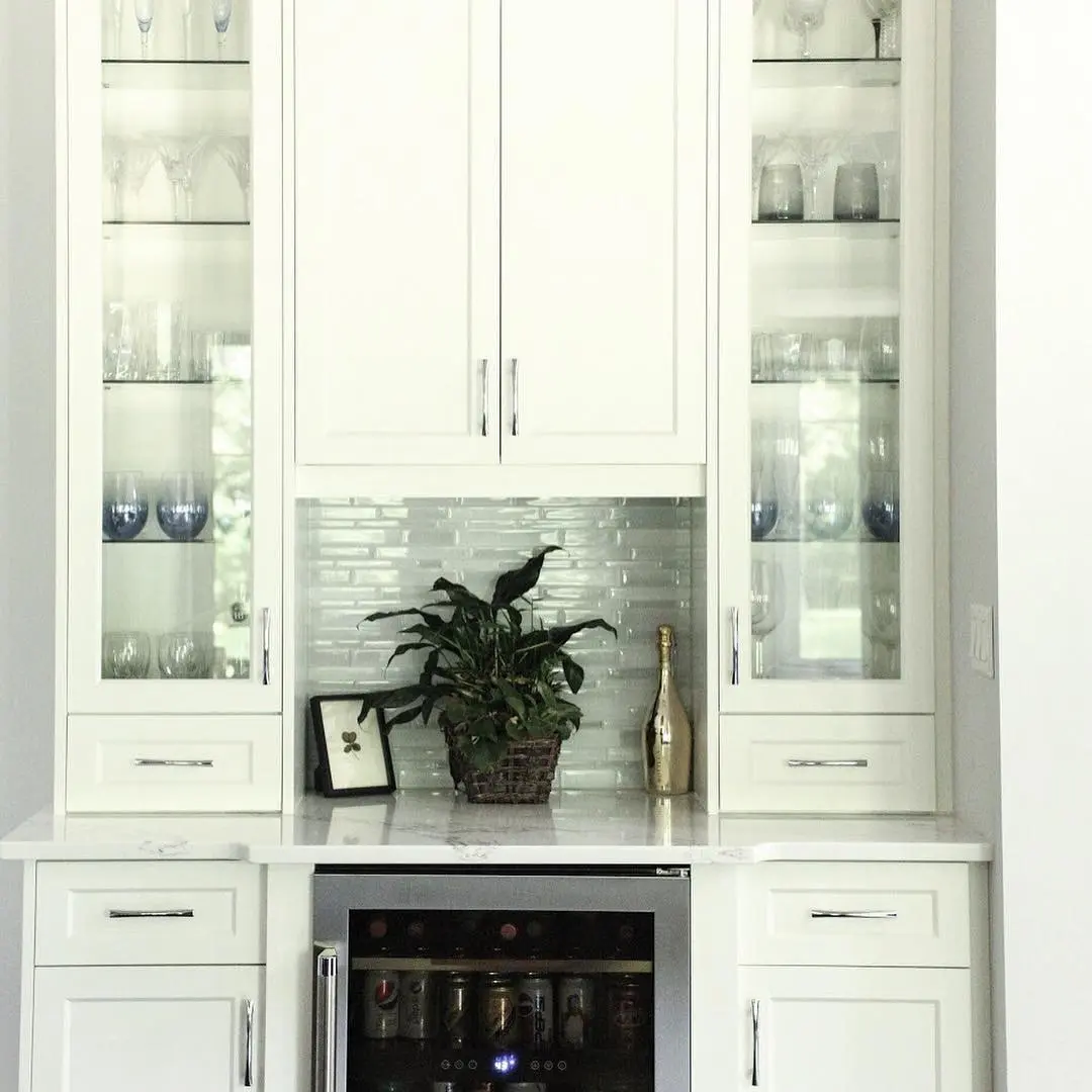 Kitchen with range hood and beverage bar cabinetry by Heirlooms Custom Cabinetry