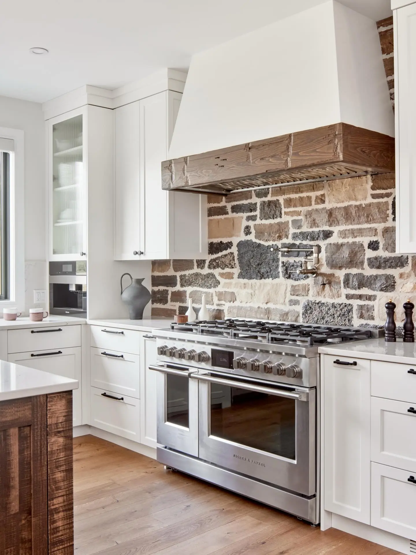 Stone kitchen cabinetry by Heirlooms Custom Cabinetry