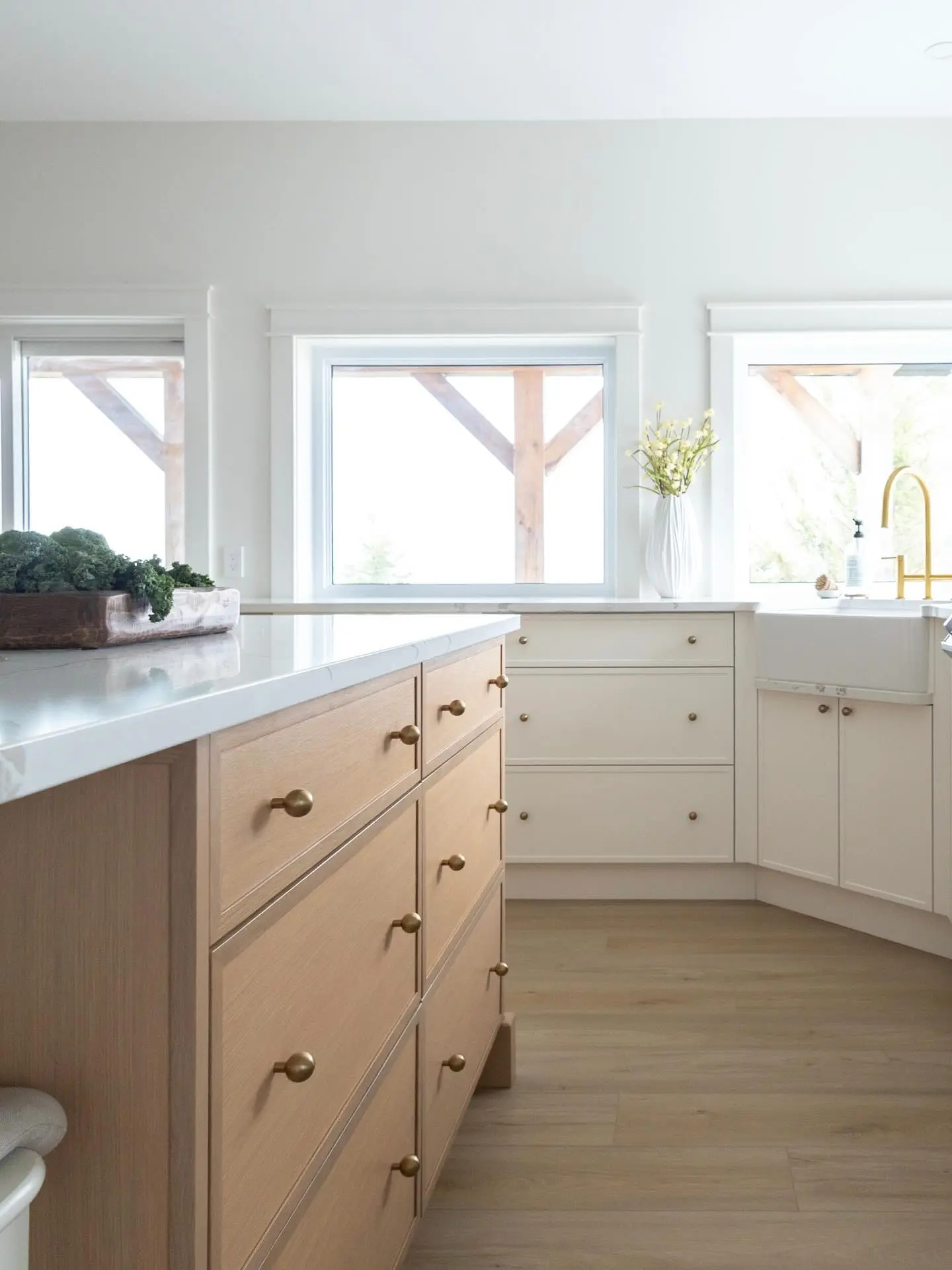 White oak kitchen with island and sink cabinetry by Heirlooms Custom Cabinetry