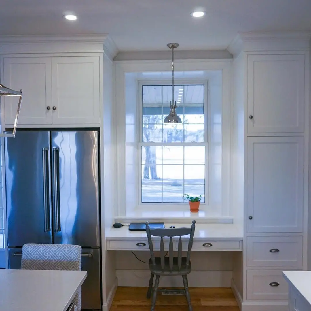 Painted kitchen with island cabinetry by Heirlooms Custom Cabinetry