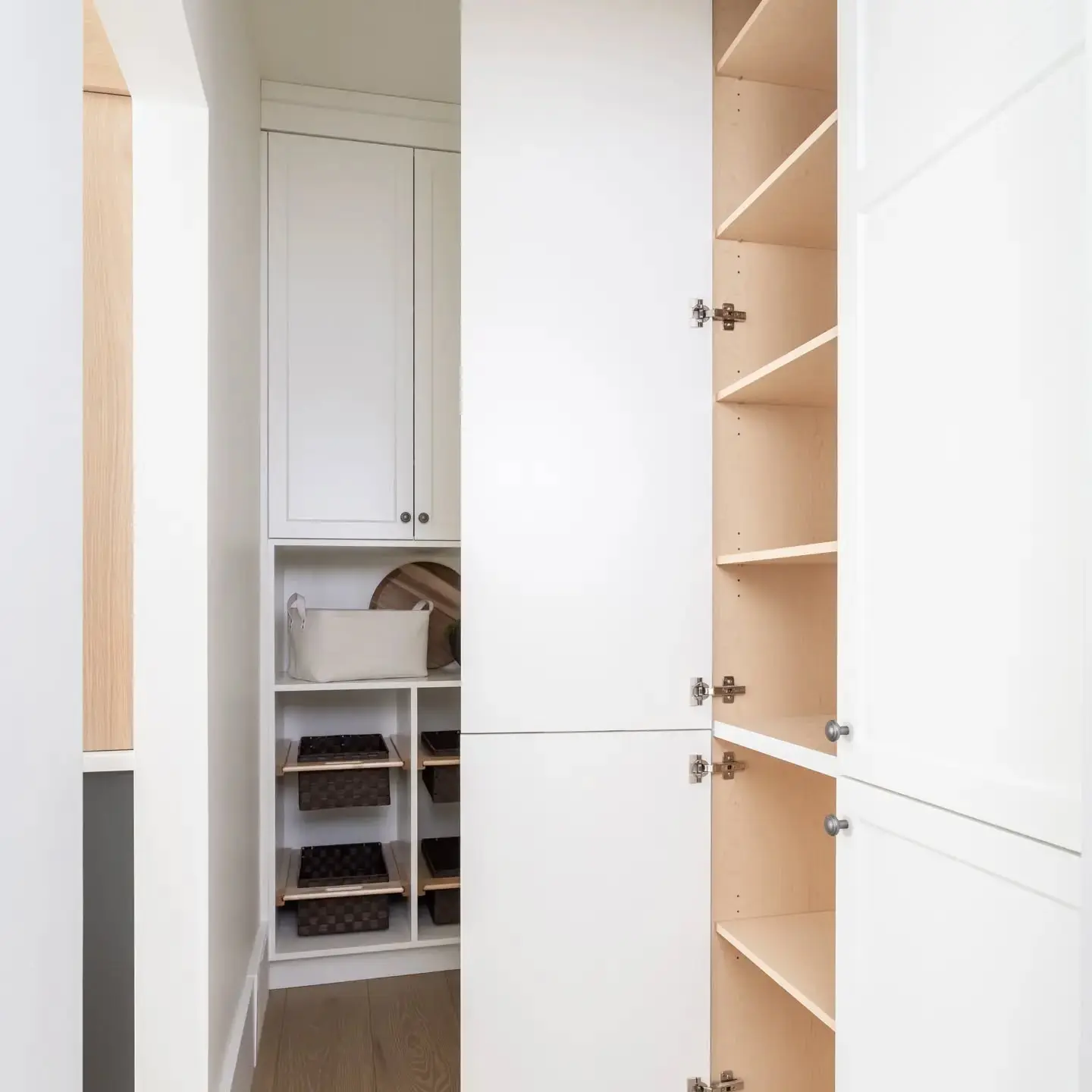 Kitchen with storage and pantry cabinetry by Heirlooms Custom Cabinetry