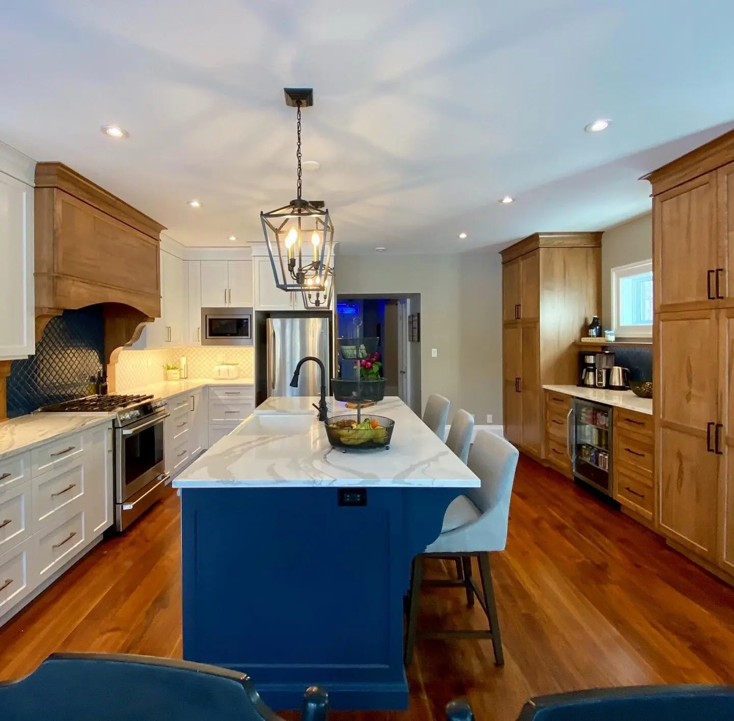 Maple kitchen with island and backsplash cabinetry by Heirlooms Custom Cabinetry