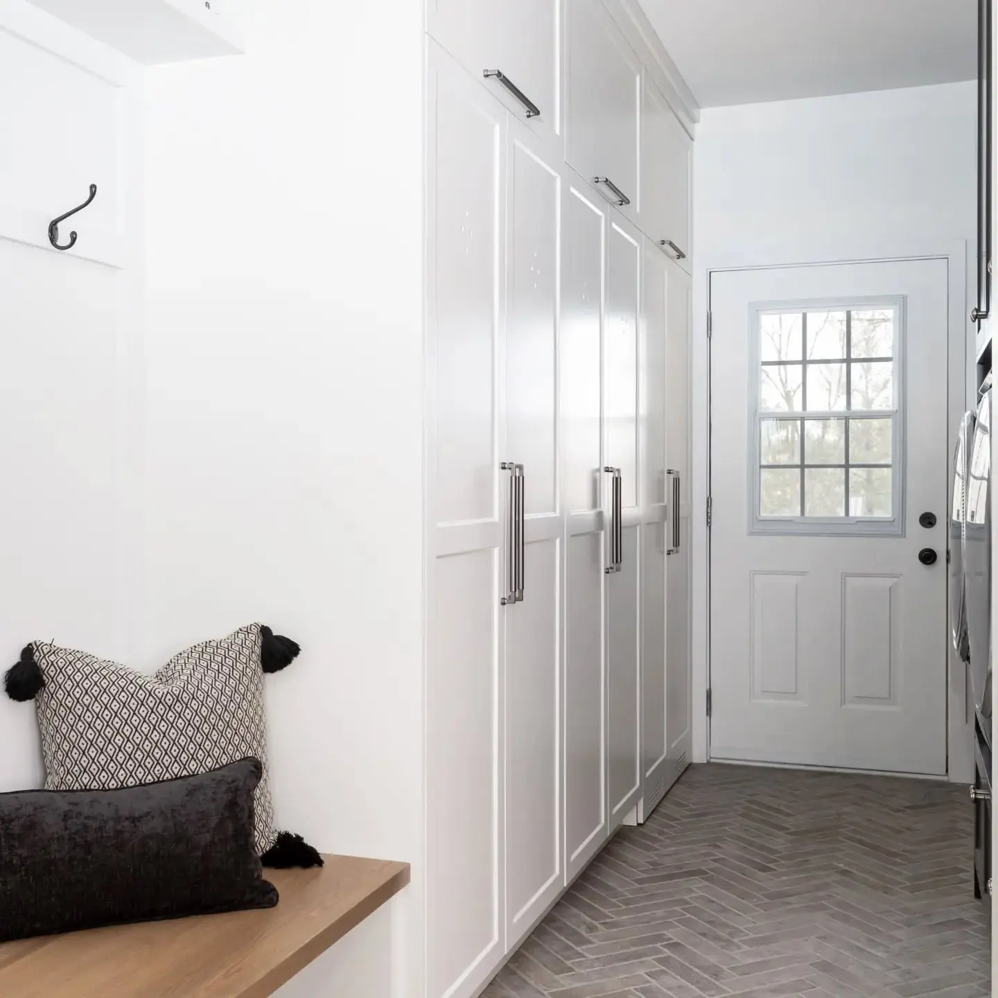 Mudroom with storage and drying rack cabinetry by Heirlooms Custom Cabinetry