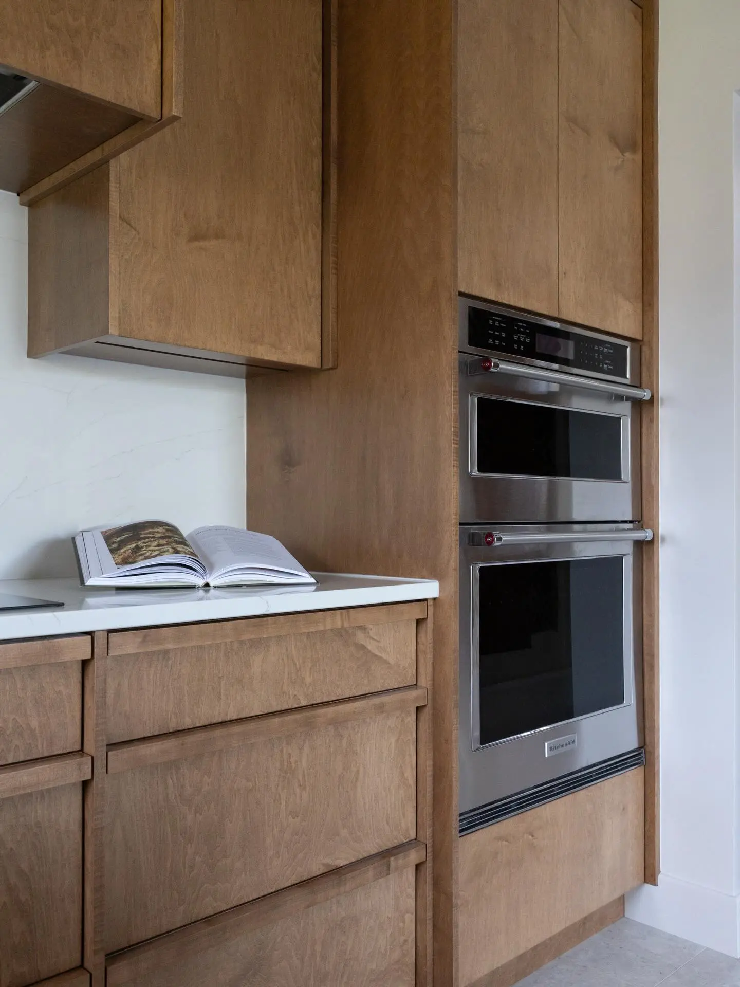 Wood kitchen with pulls cabinetry by Heirlooms Custom Cabinetry