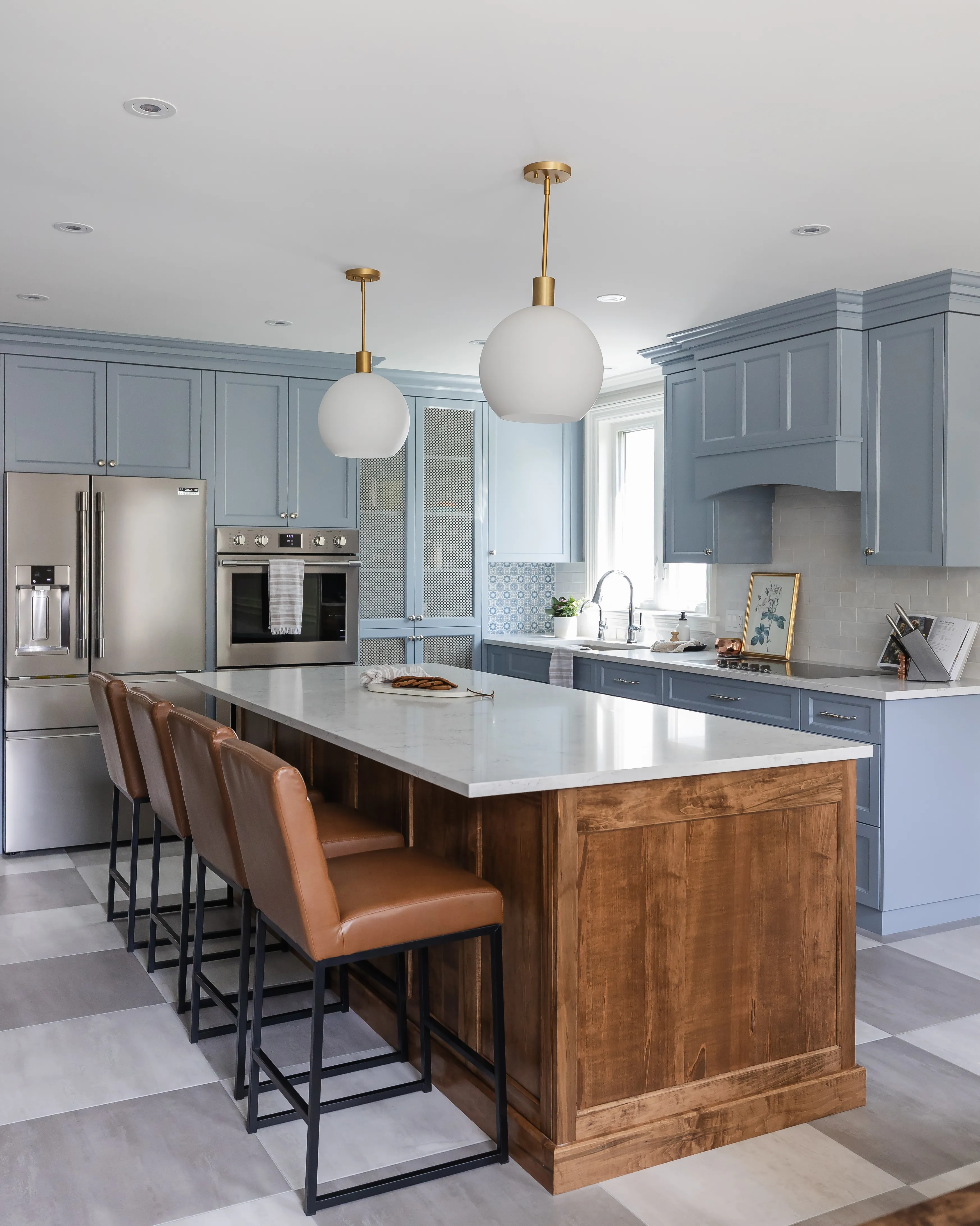 Custom kitchen with blue cabinetry and wood island